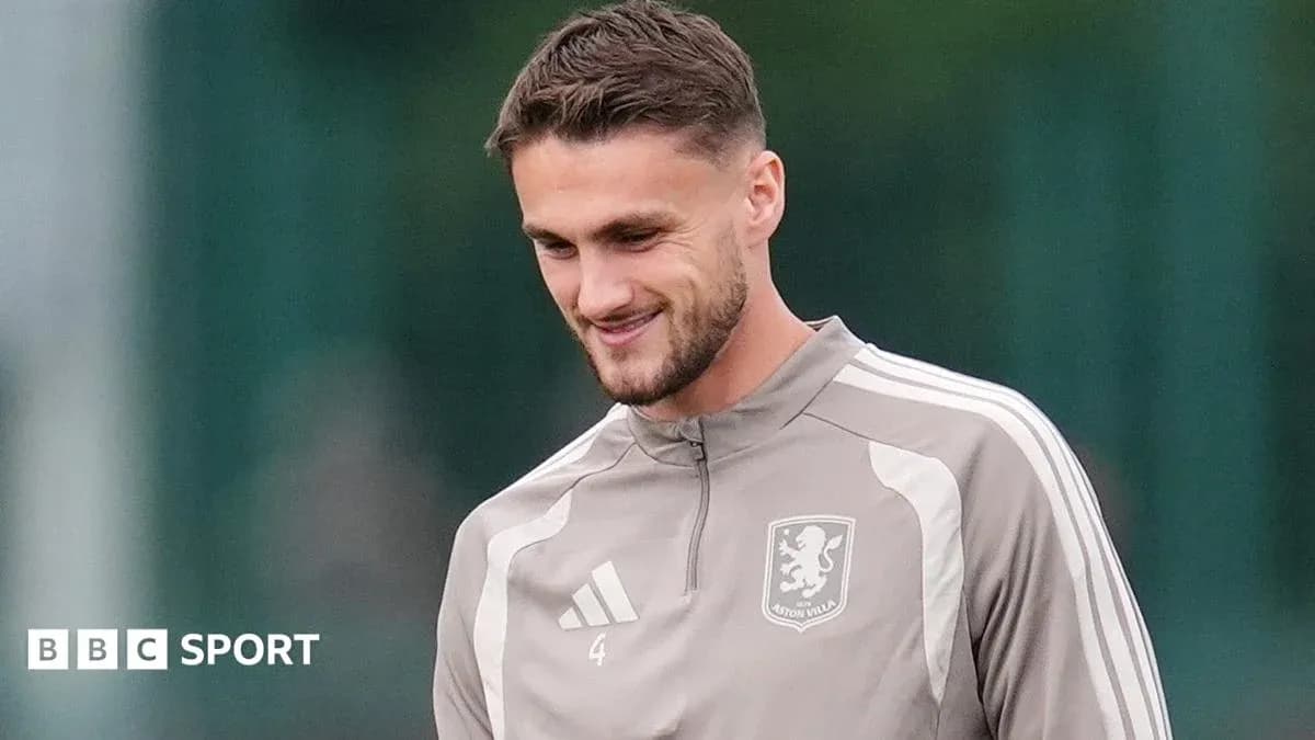 Player in Aston Villa training kit smiling outdoors