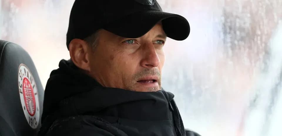 Coach observing match from the sidelines in rain
