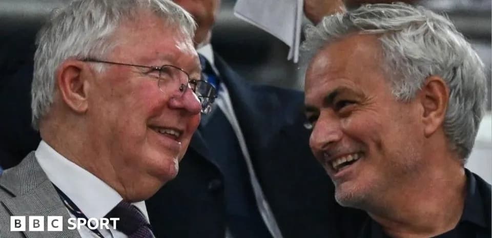 Two men smiling and chatting in stadium seats