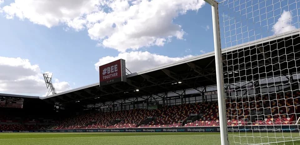 View of goalpost and empty stadium under cloudy sky