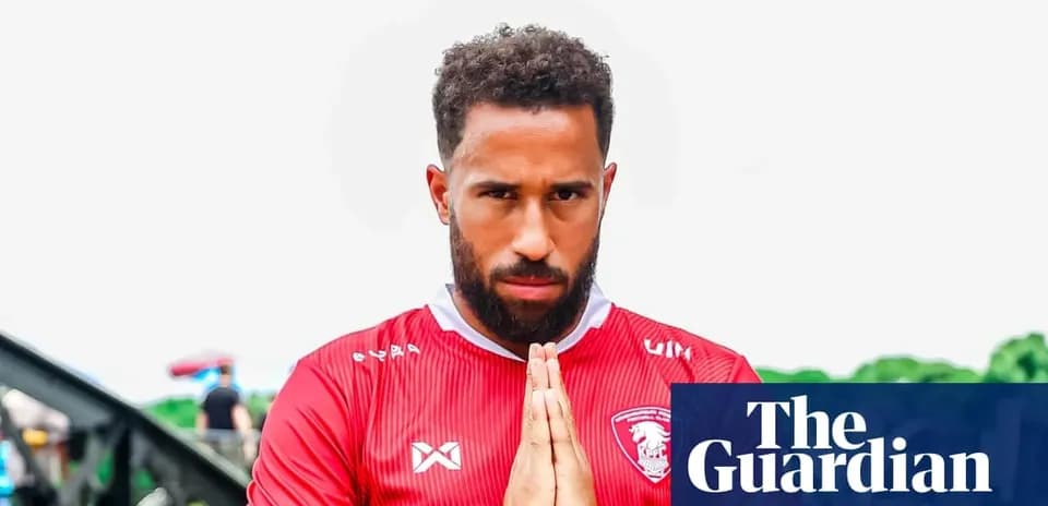 Player in red jersey posing with hands together