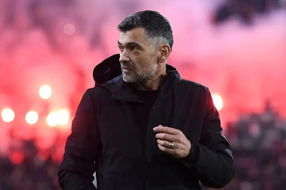 Coach observing match with smoke in background