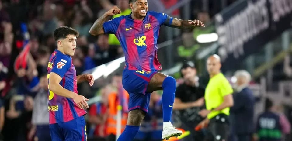 Barcelona players celebrating a goal on the pitch