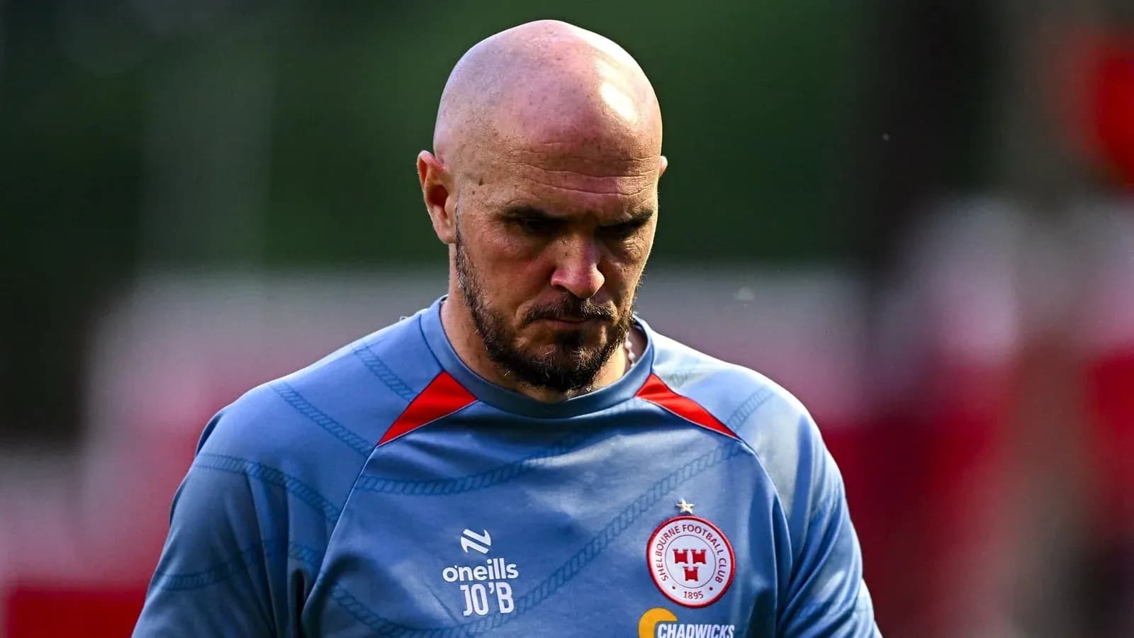 Player walking off training pitch in club jersey