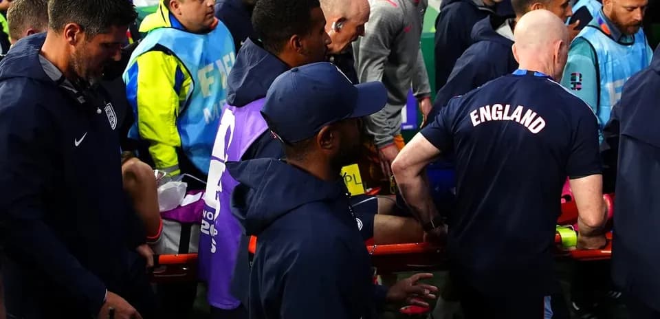 Medical staff assisting injured player off the field