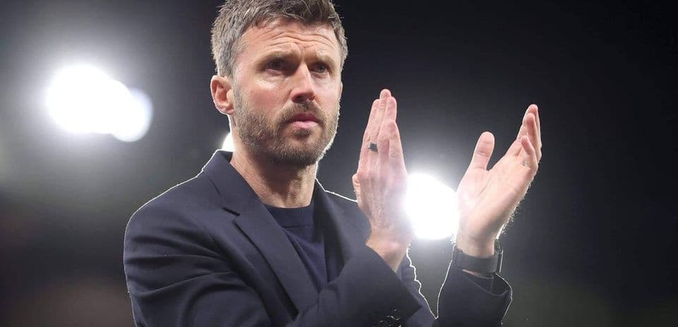 Manager applauding during a match at night