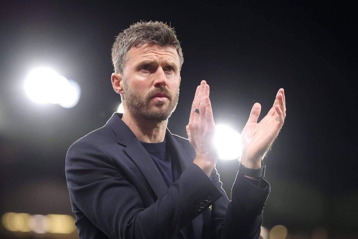 Manager applauding during a match at night