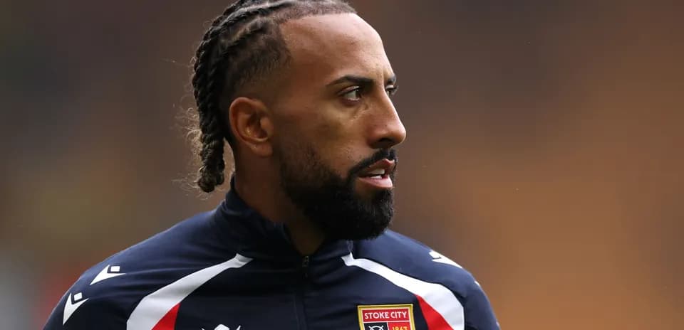 Player wearing Stoke City jacket on the field