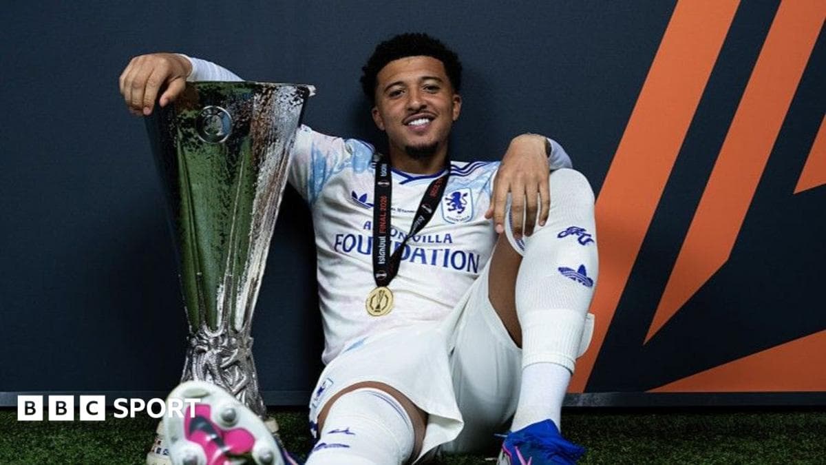 Player celebrating with UEFA trophy and medal