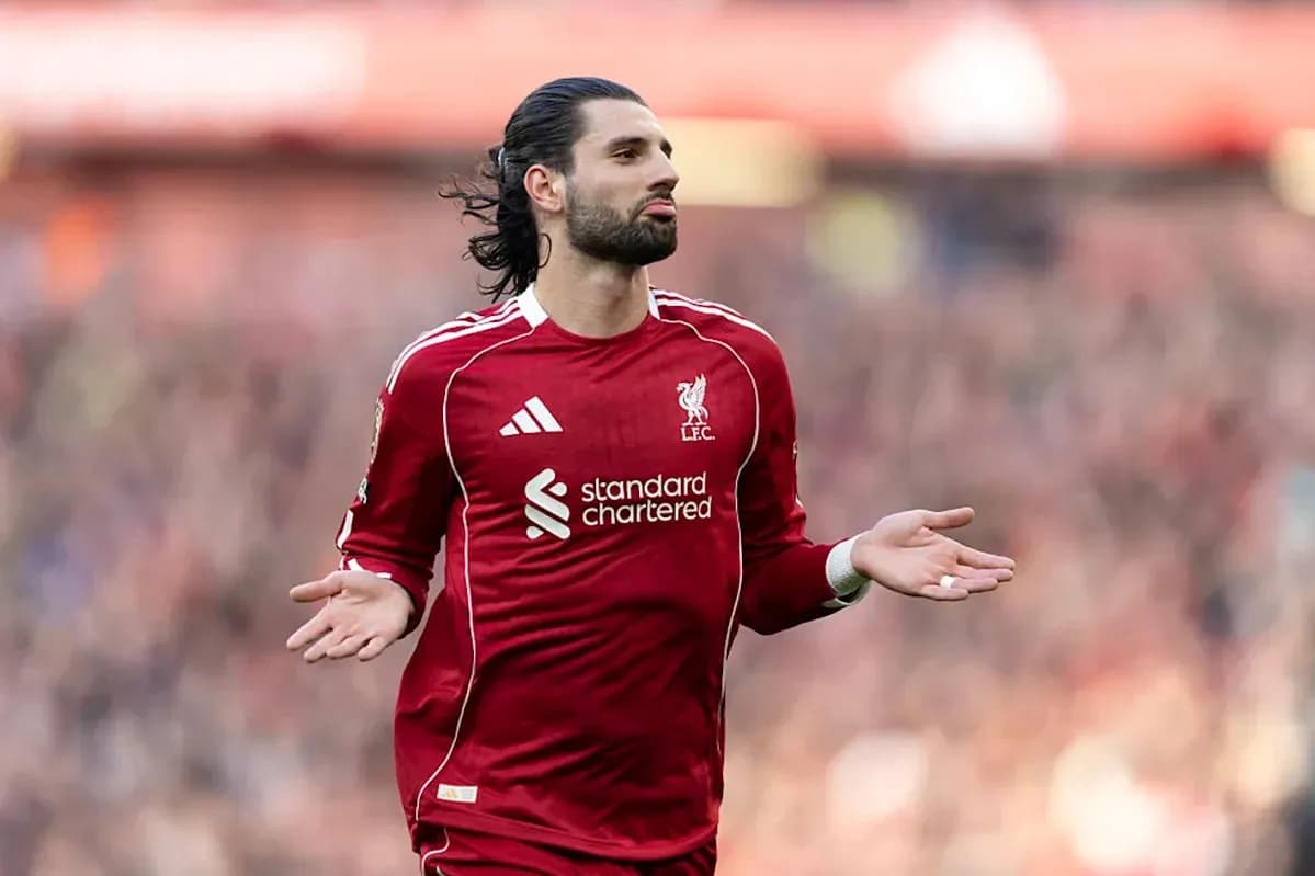 Player gesturing during match in Liverpool kit