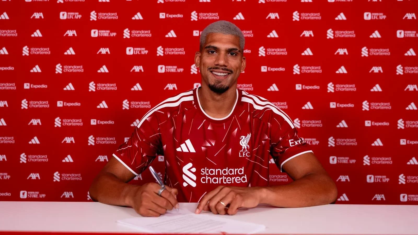Player signing contract at Liverpool FC announcement event