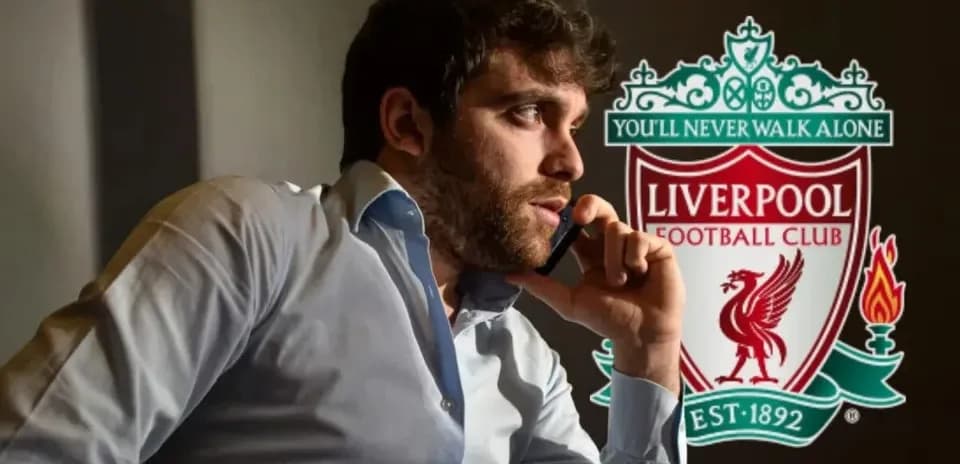 Person on phone with Liverpool FC logo in background