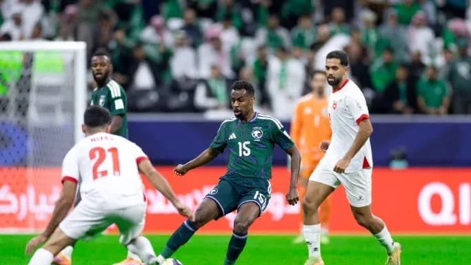 Saudi player dribbling past defenders during match