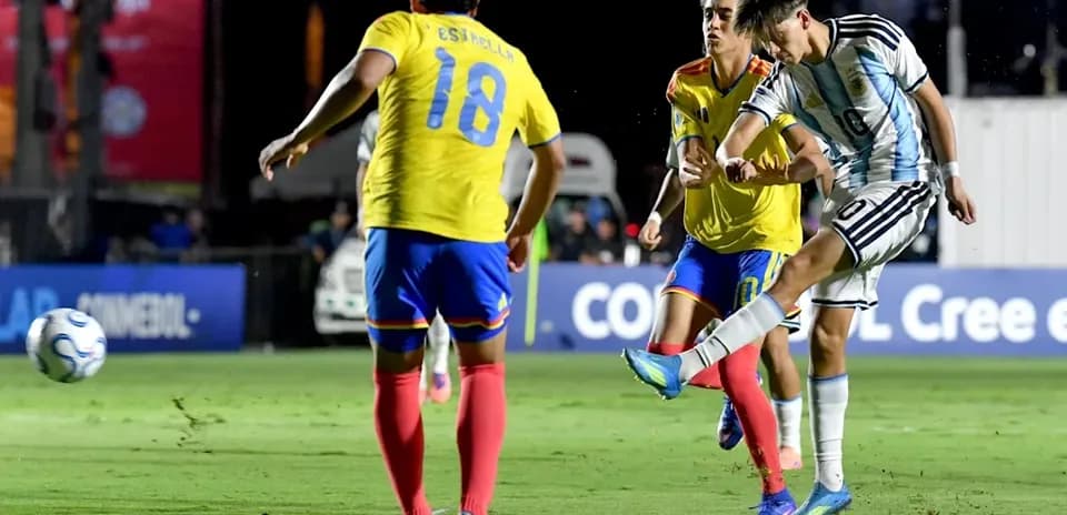 Argentinian player kicking ball in match against Ecuador