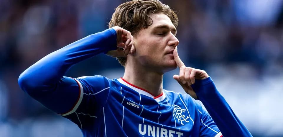 Player celebrating with shushing gesture after scoring
