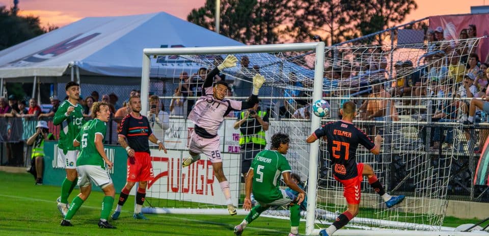 Goalkeeper jumping to save a shot on goal