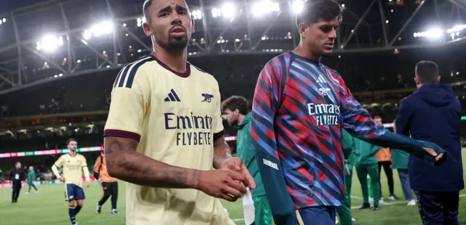 Two Arsenal players walking off the pitch