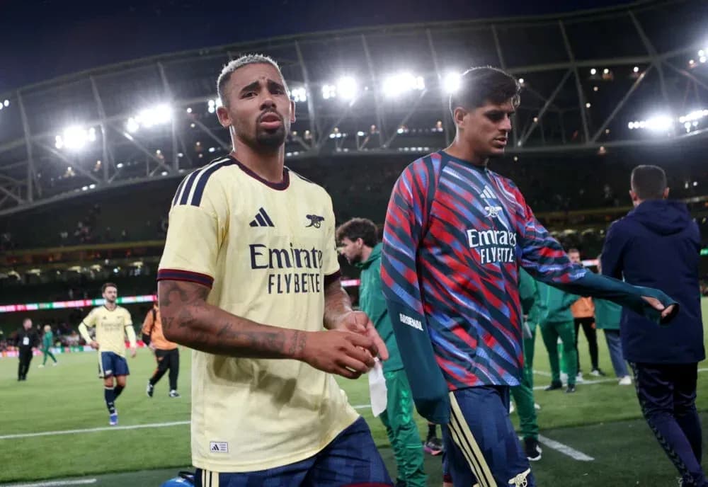 Two Arsenal players walking off the pitch