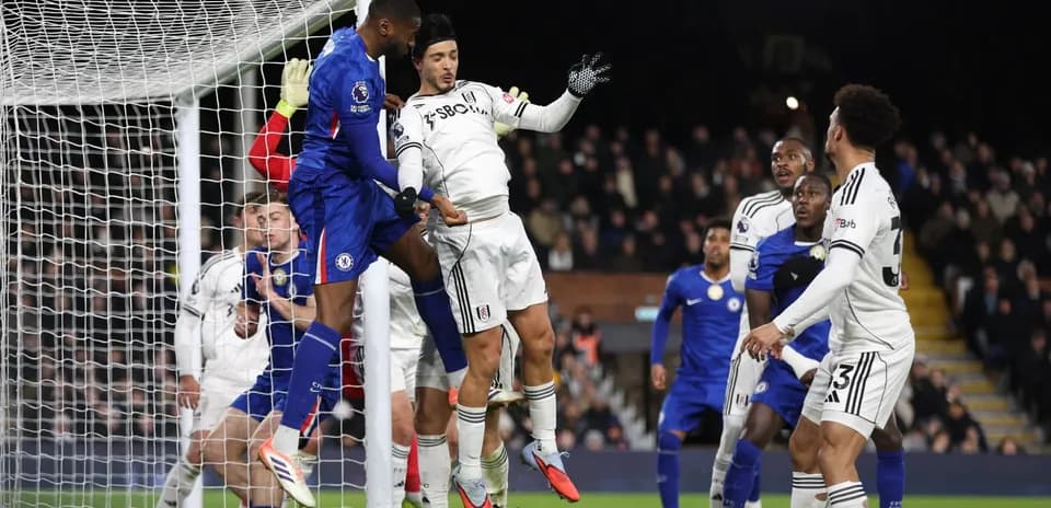 Chelsea player challenging for a header against Fulham