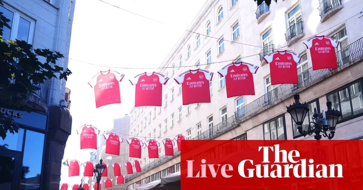 Arsenal jerseys hanging above street in city