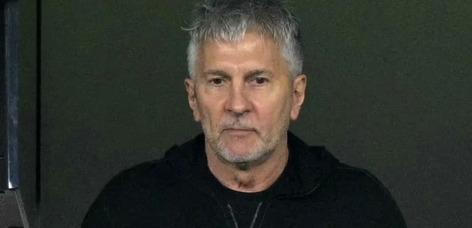 Man with gray hair in dark hoodie
