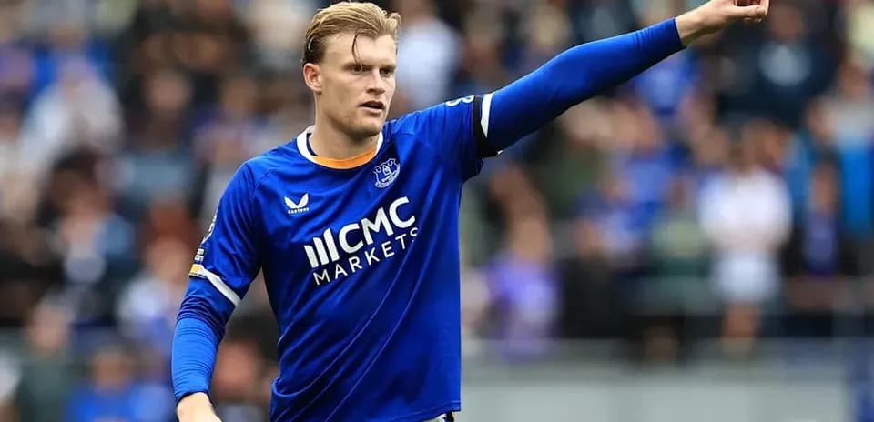 Player in blue jersey signaling during match