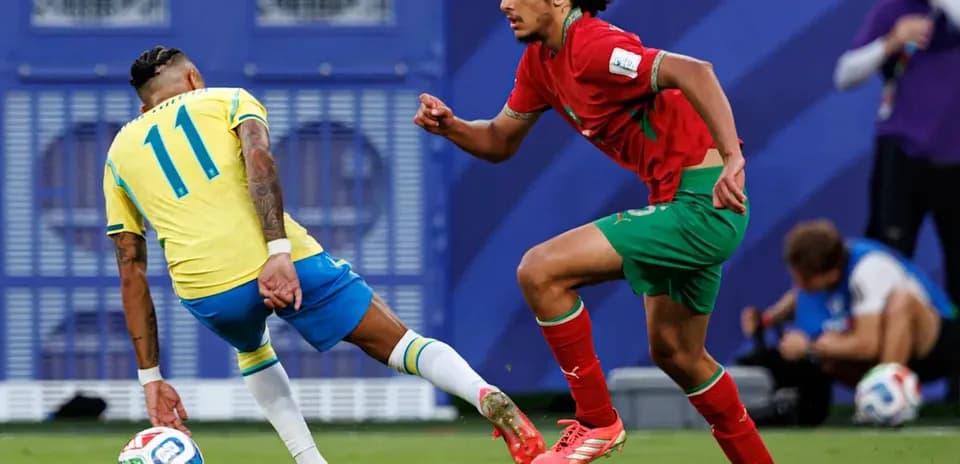 Brazilian player dribbling past Moroccan defender