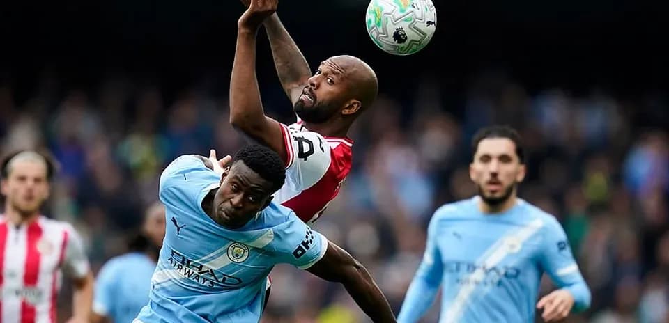 Players competing for the ball during Manchester City match
