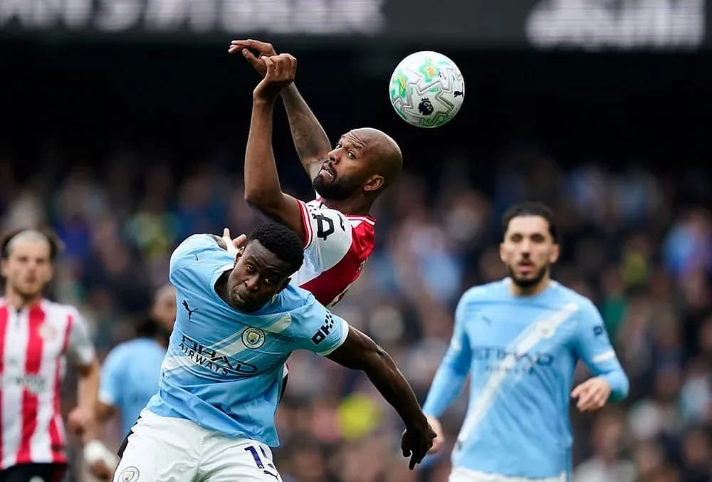 Players competing for the ball during Manchester City match