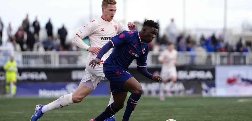 Cavalry FC player dribbling past opponent