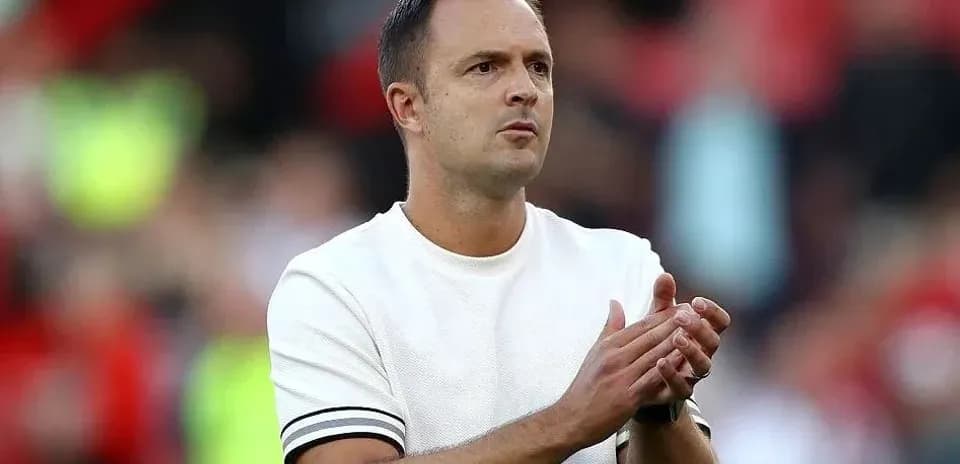 Coach applauding during match on the sidelines
