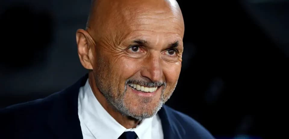 Coach smiling during a press conference event