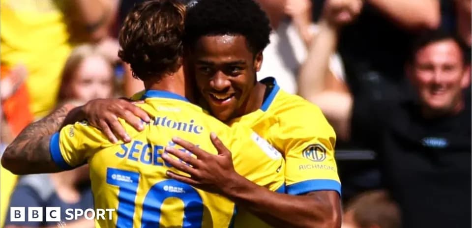 Two players celebrating a goal with embrace