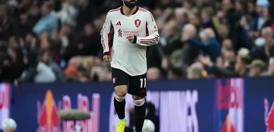 Player in white jersey running on the pitch
