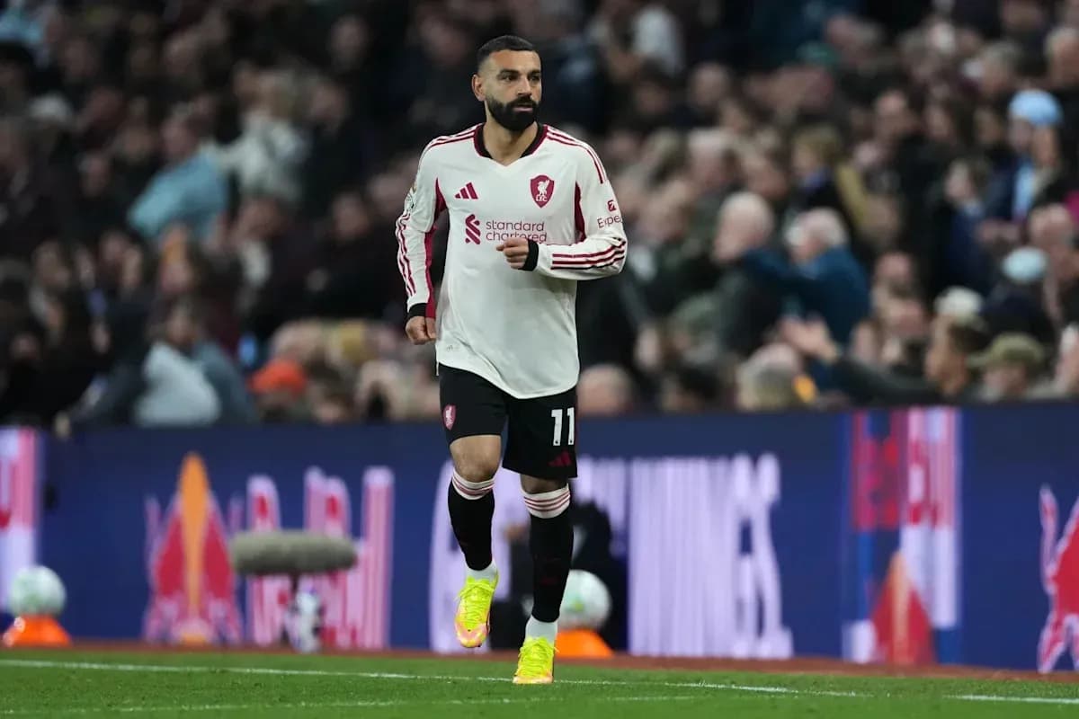 Player in white jersey running on the pitch