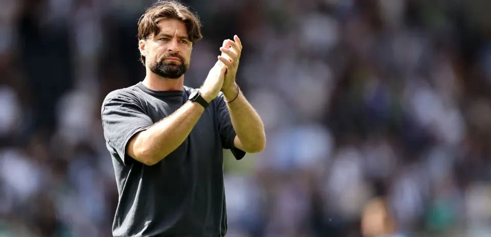 Coach applauding to the crowd after the match