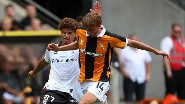 Two players competing for the ball during match