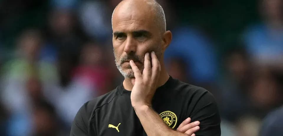 Coach observing the match with a pensive expression