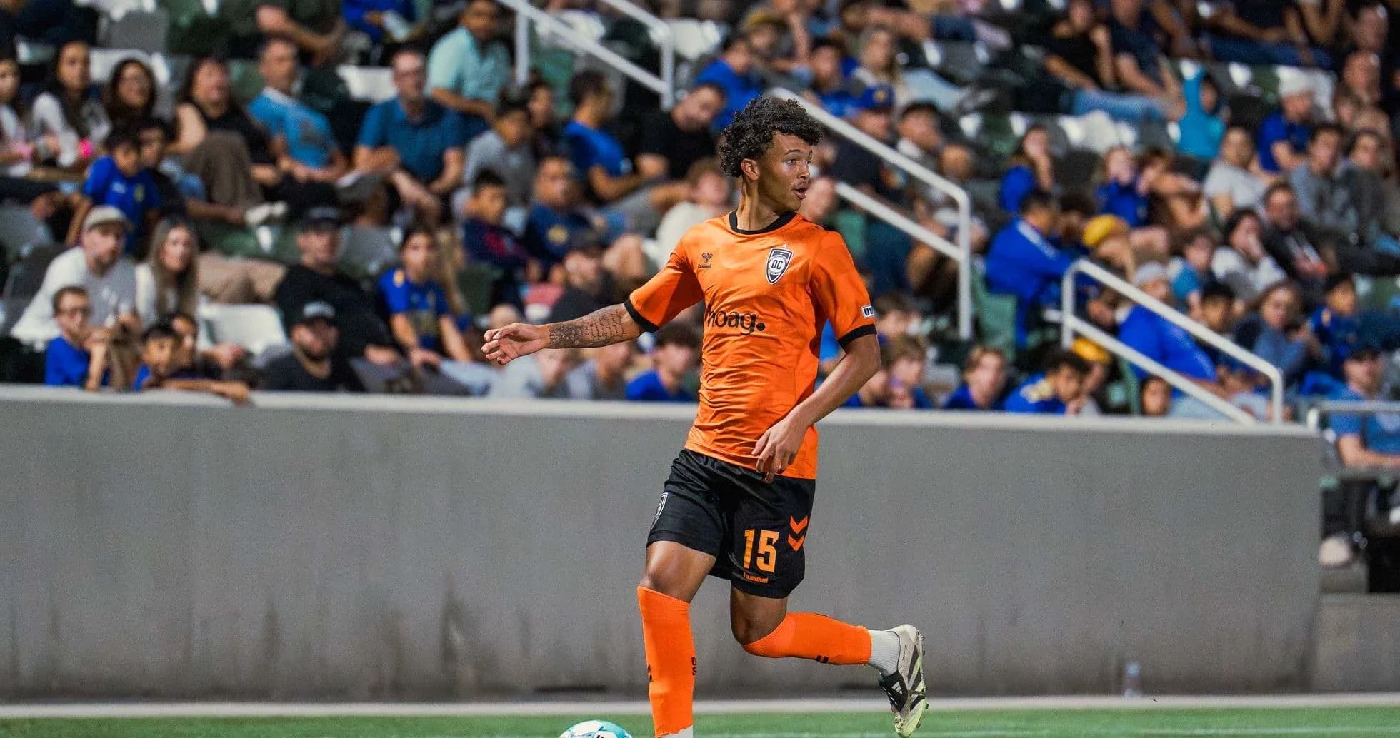 Player in orange jersey during football match