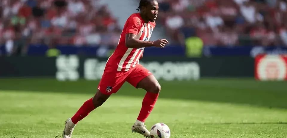 Atletico Madrid player dribbling the ball on field