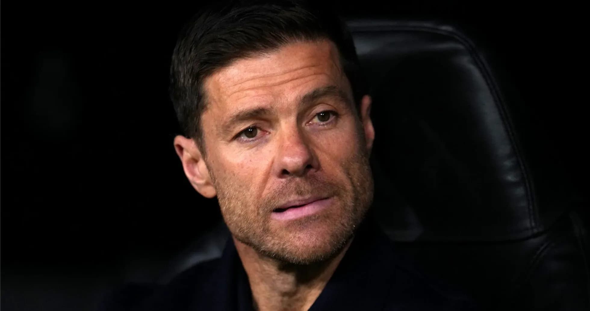 Coach sitting on bench during a match