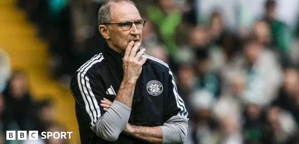 Coach observing the match with a thoughtful expression