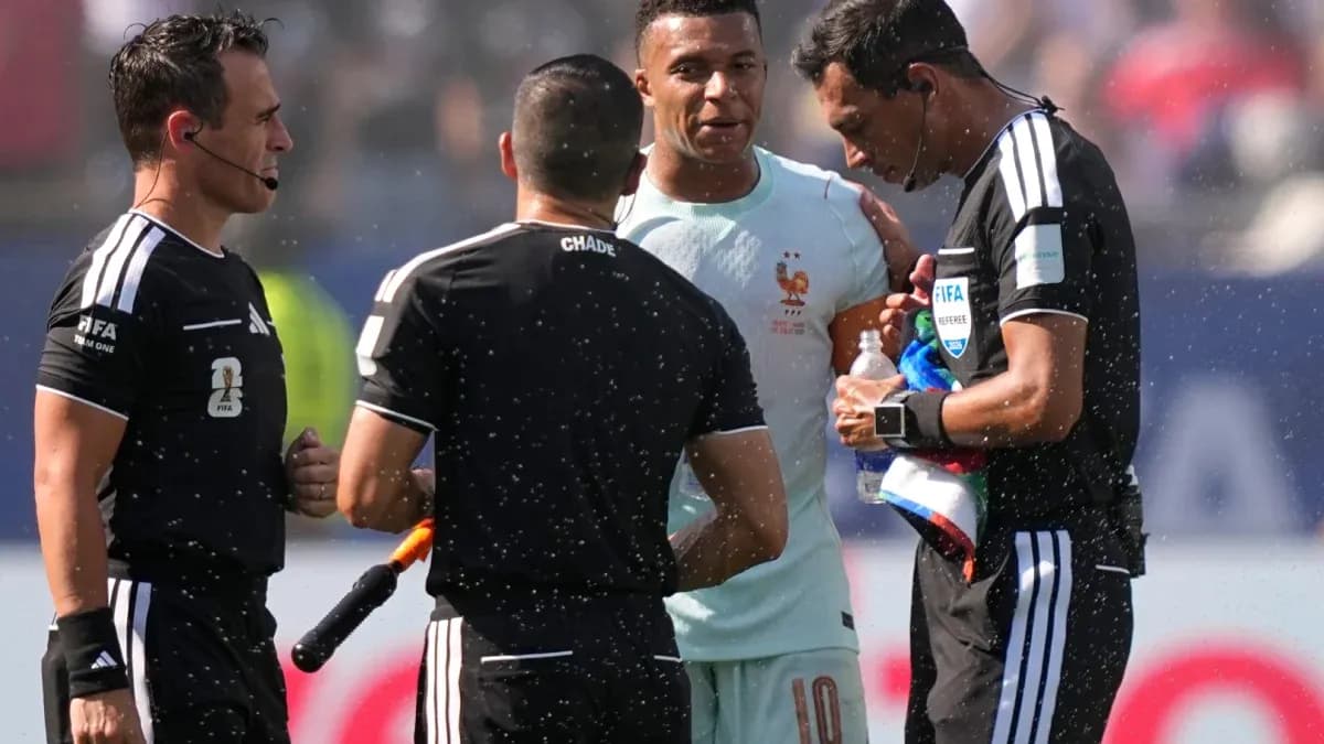 Kylian Mbappé speaking with referees during match