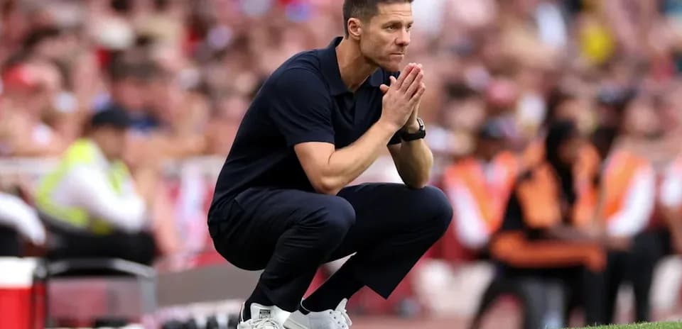 Coach observing match while crouching on sidelines