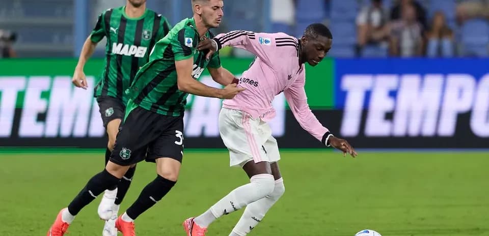 Sassuolo player tackles Juventus player during match