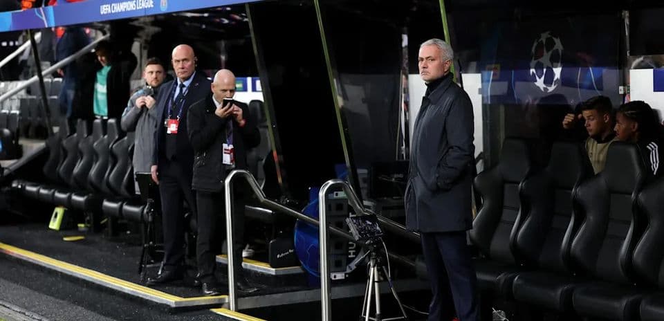 Manager observing from the dugout during UEFA match