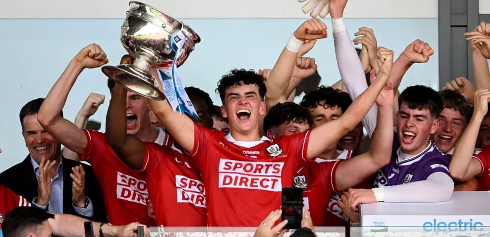 Players celebrating with trophy after winning match