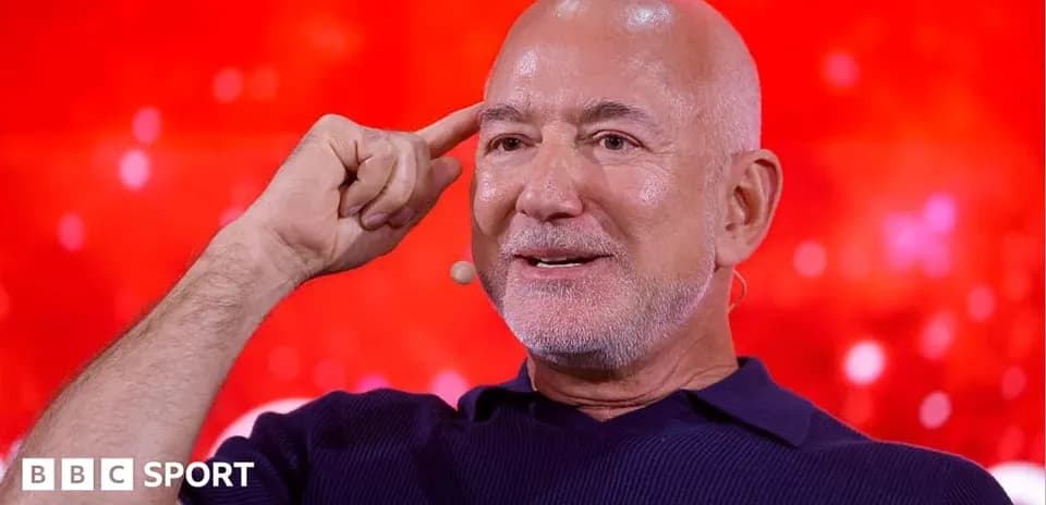 Man speaking with hand on forehead during discussion