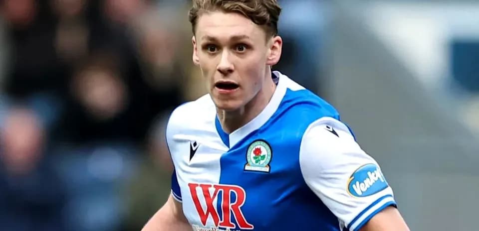 Player in Blackburn Rovers kit running on the field