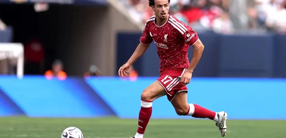 Liverpool player dribbling ball during match